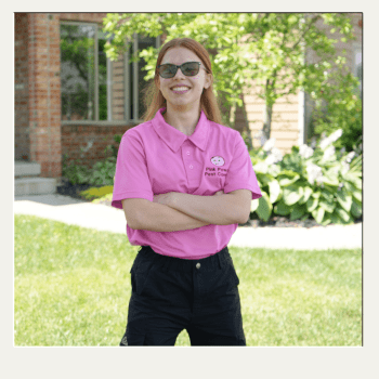 Sarah Pierce owner of Pink Power Pest Control in Troy OH standing outside a home.